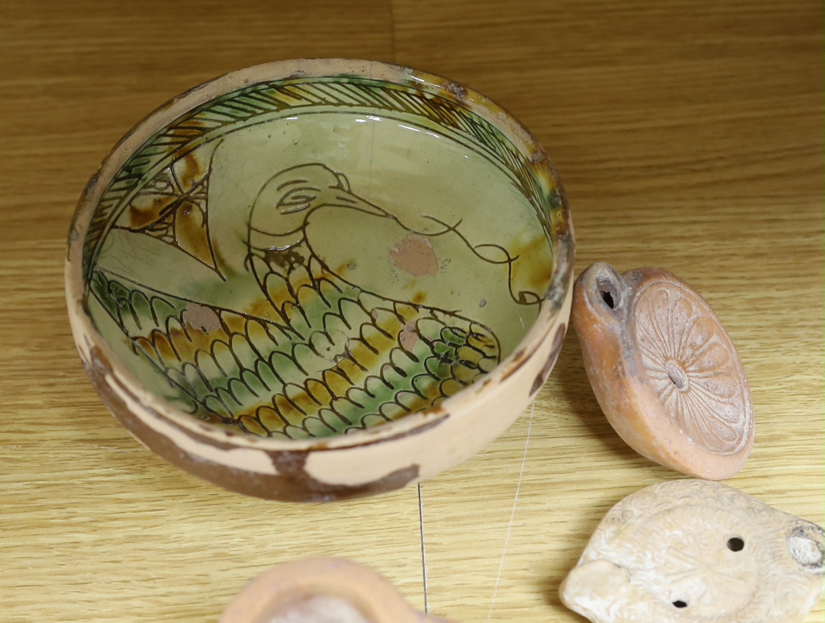 Assorted Cypriot pottery ‘antiquities’, to include bichrome pottery vessels, Cypro-Archaic, c.750-600 BC, Roman terracotta oil lamps, a Byzantine sgraffito ‘phoenix’ bowl, 13th/14th century, 16cm. Provenance - collected